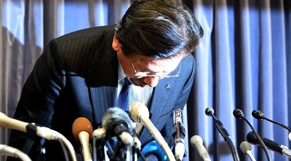 Mitsubishi Motors president and COO Tetsuro Aikawa enters the room to start his press conference at the transport ministry in Tokyo on Tuesday. Mitsubishi Motors said it has been using dodgy fuel-efficiency testing for 25 years and admitted it has no idea of the scale of the cheating that has plunged it into crisis.
