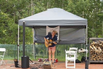 skarlett woods playing acoustic guitar and singing
