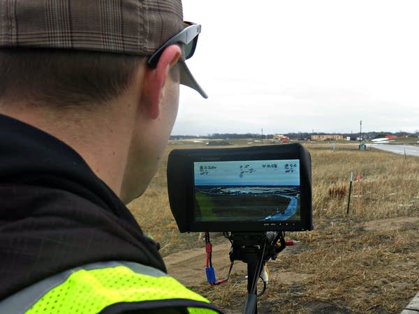 Joey Schmit monitors live video from his drone.