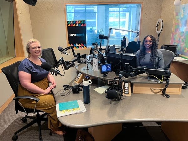 two women smiling in a broadcast studio