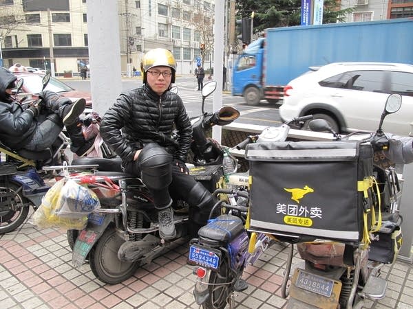 Zhang Xu is one of the top food deliverers in his district, earning more than the average white-collar salary.