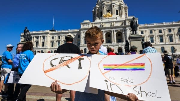A children holds a sign