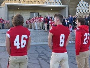St. John's football players line up outside of the Abbey Church.