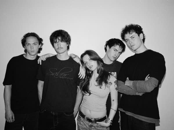 Five people pose for a portrait.