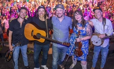 Five people standing onstage in front of an audience