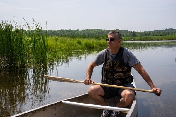 a man canoes on a lake