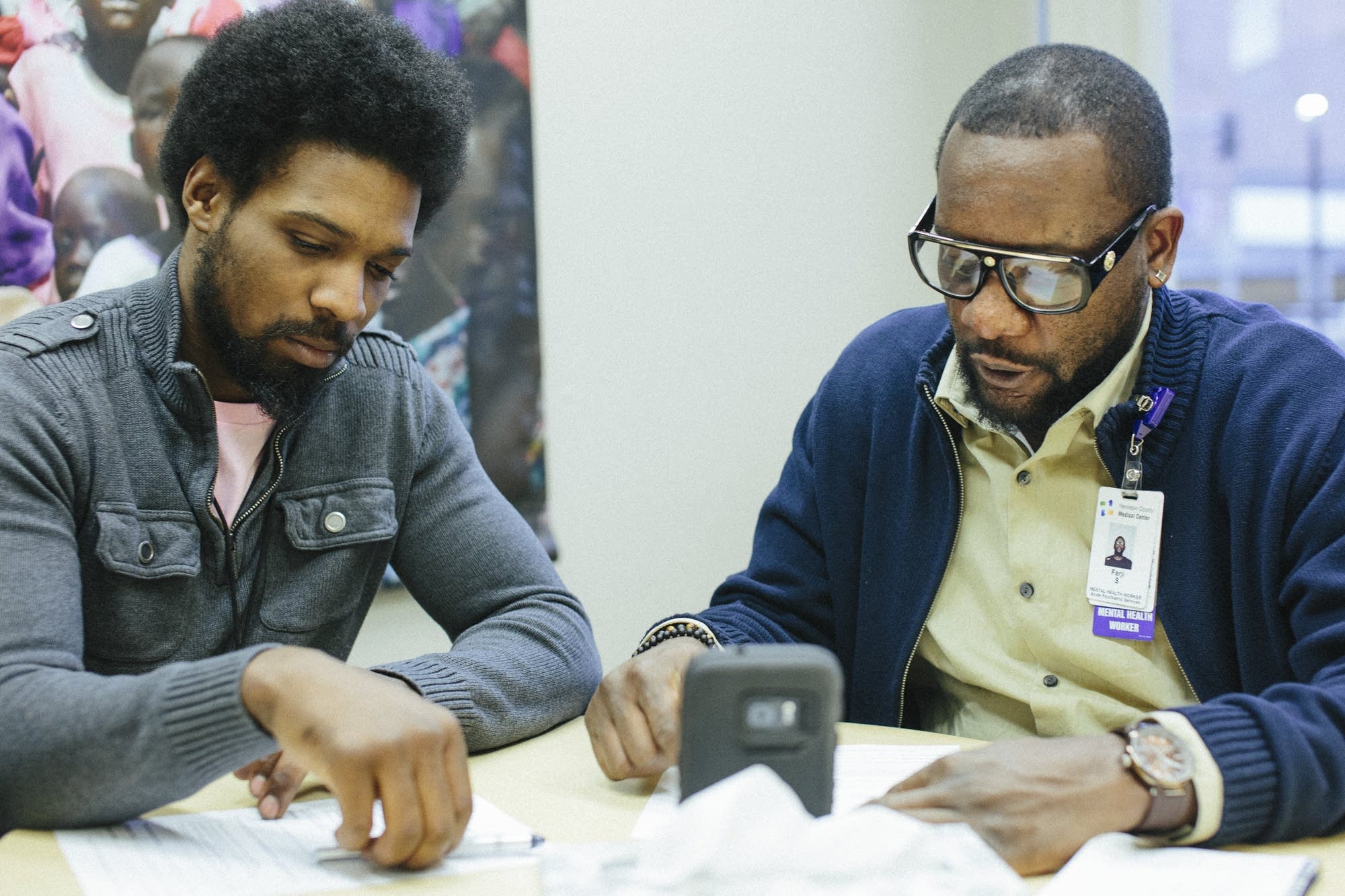 D'Andre Alexander, left, and Farji Shaheer watch a video.