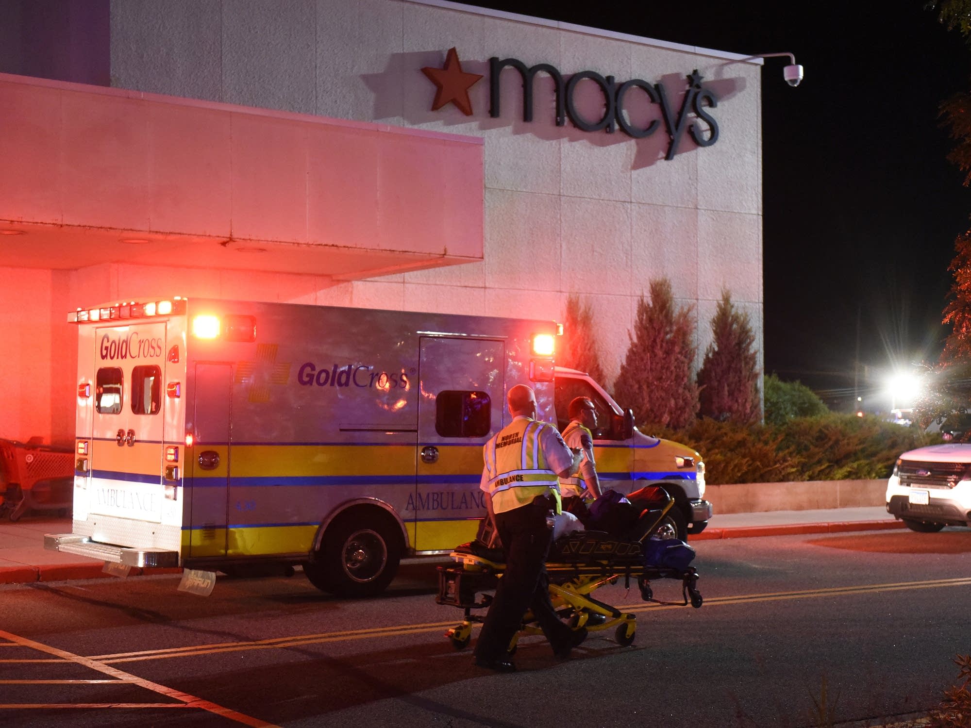 EMT workers move an empty stretcher.