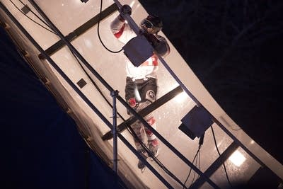 A racer uses the railing to climb the wall.