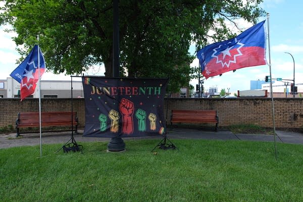 A sign in black green yellow and red reads "Juneteenth."