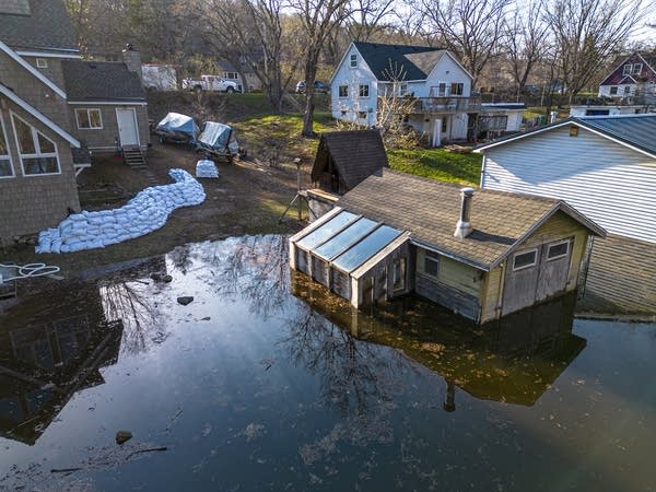 A building sits surrounded by flood water