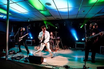 A four-piece band performing onstage