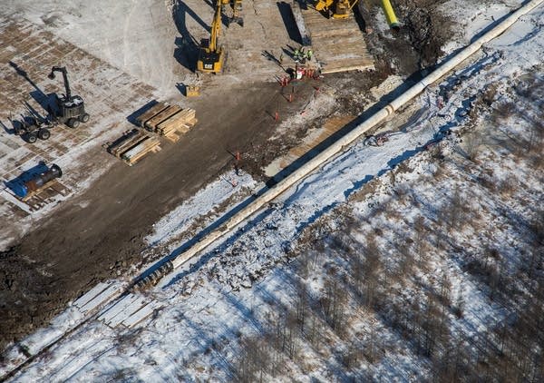 Construction crews work to replace a segment of Enbridge's Line 4.