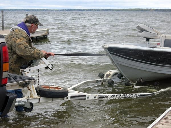 Rick Carlson pulls his boat from Lake Bemidji.