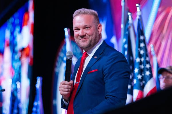 Adam Schwarze holding a mic