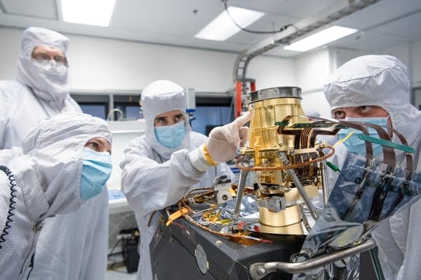 Engineers in a clean room at NASA’s Jet Propulsion Laboratory in Southern California in April 2023 examine the imaging spectrometer that will ride aboard the first of two satellites to be launched by the Carbon Mapper Coalition. The instrument will help researchers detect emissions of carbon dioxide and methane from sources on Earth’s surface from space. Photo Courtesy of Carbon Mapper/JPL-Caltech