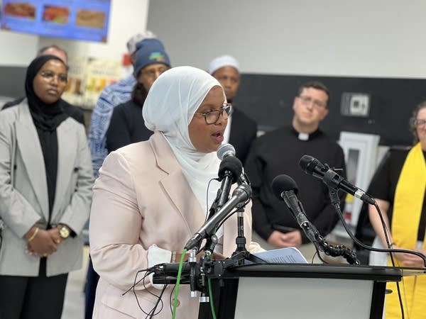 woman speaks at podium