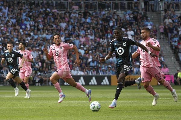 Players chase the ball