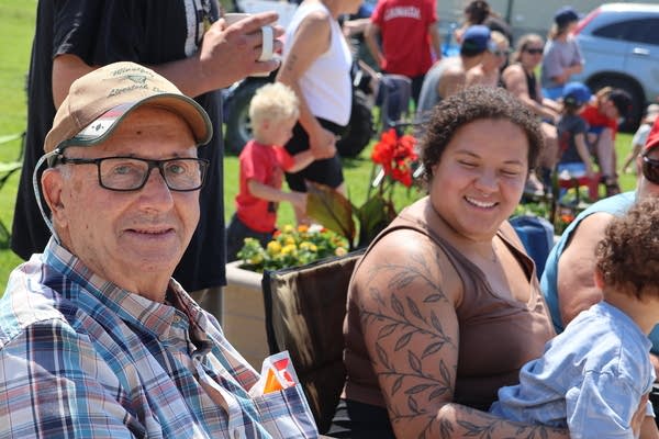 People sit at a parade