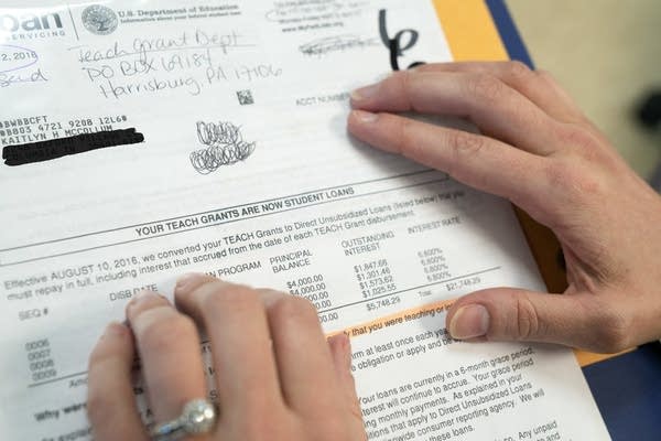 Kaitlyn McCollum points to documents.