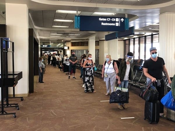 Passengers arriving in Honolulu line up to have their COVID-19 test results verified. 8,000 travelers arrived on the first day of the testing program, more than triple the daily number from previous weeks.