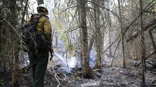 a firefighter cleans up smoky areas