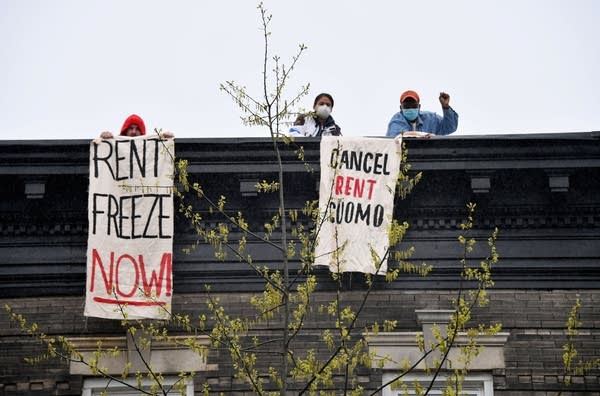 Rent protestors on top of a building