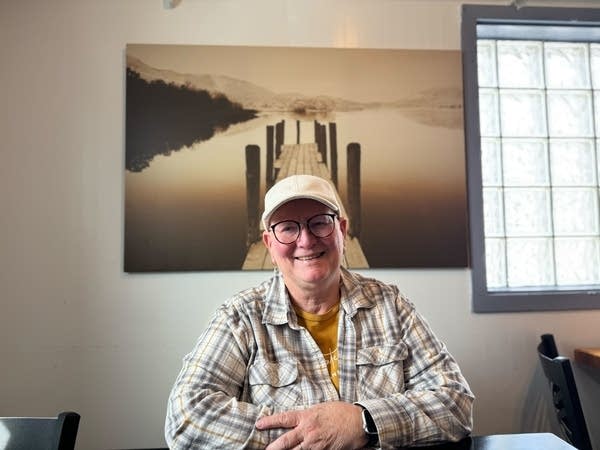 person posing for photo in front of boardwalk pic