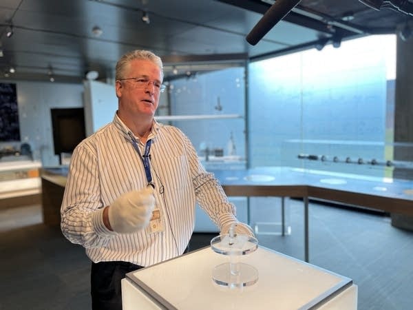 Ed Eckert, the Nokia Bell Labs archivist, stands behind the first transistor.