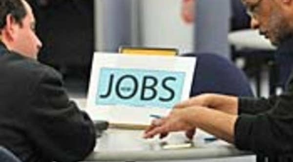 A job seeker, left, talks with a career counselor at the Career Link Center One Stop job center in San Francisco.