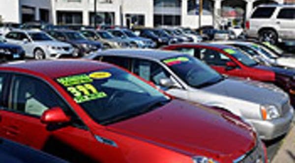 Cars manufactured by General Motors, which include Cadillacs, Pontiacs, GMC and Saab's, wait for buyers at a dealership in Los Angeles.