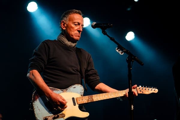 Bruce Springsteen playing a guitar.