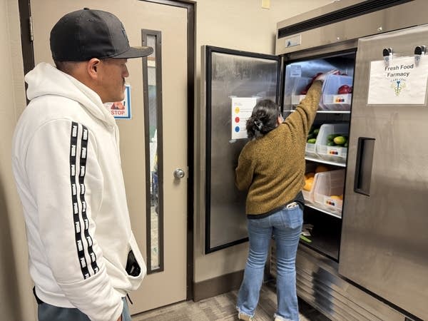 A person reaching into a fridge