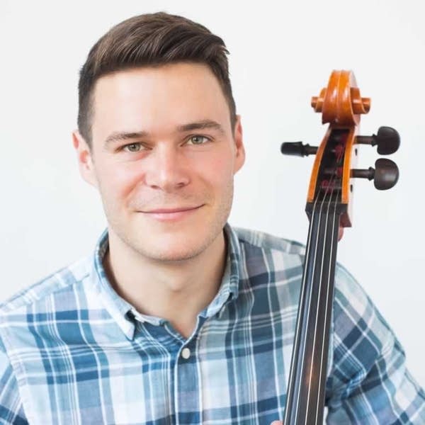 Portrait of a man holding a cello