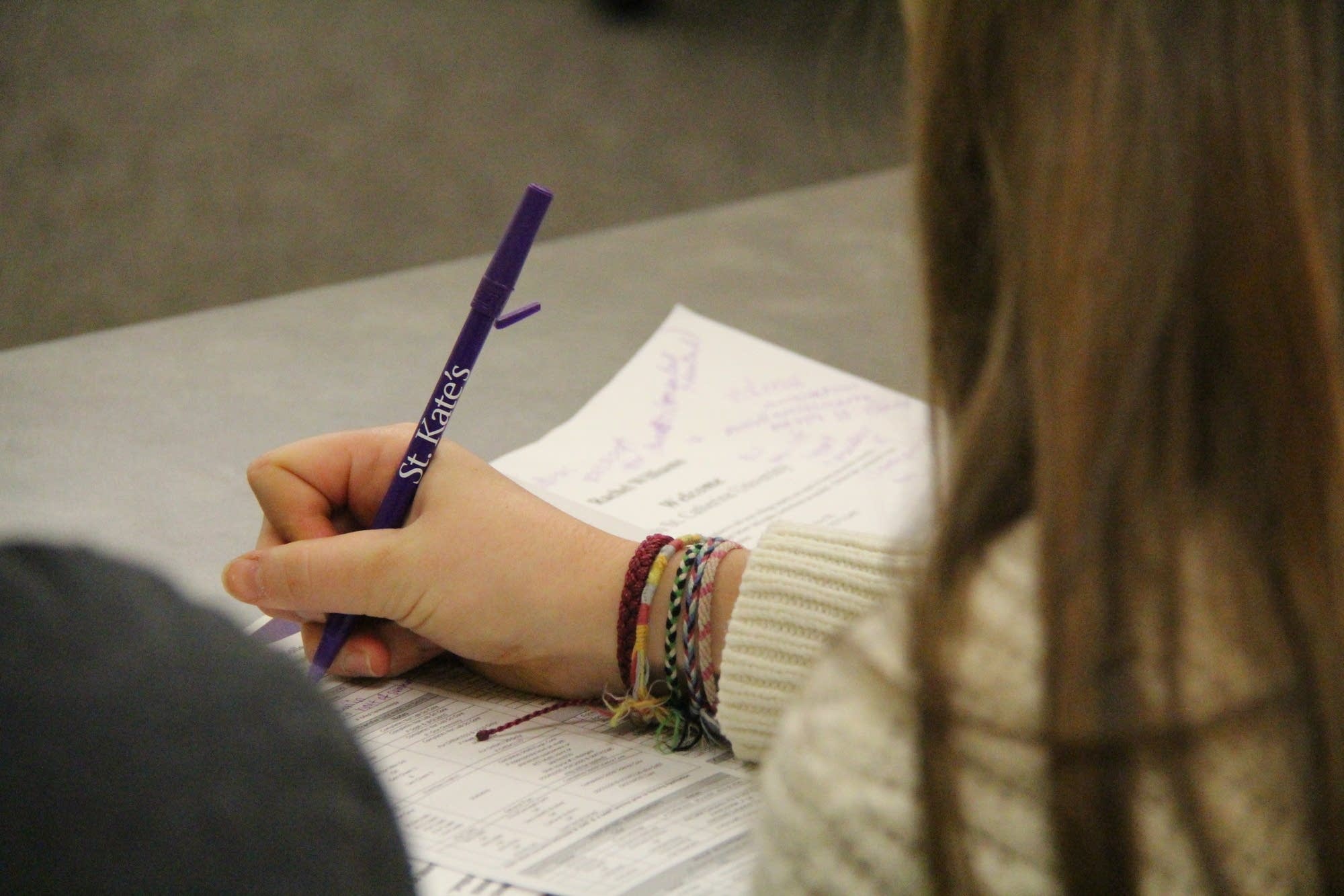 A student takes notes during an information session.