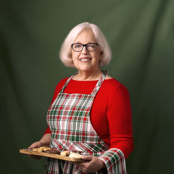 Anne Robinson, owner of the Scottish Gourmet USA, holding a plate of Scottish goods