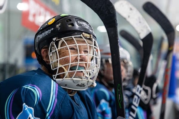 hockey player watches action from bench