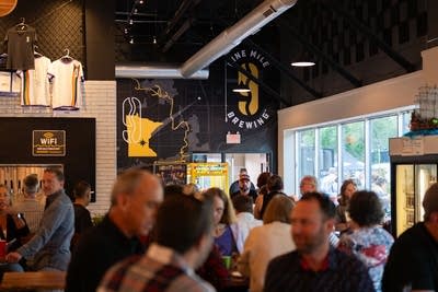 Patrons gather inside a craft brewery's taproom