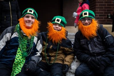 Three boys wear fake beards