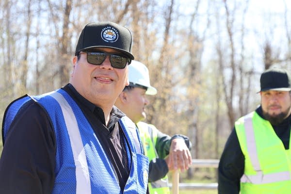 Robert Blake wearing sunglasses, black hat and blue vest