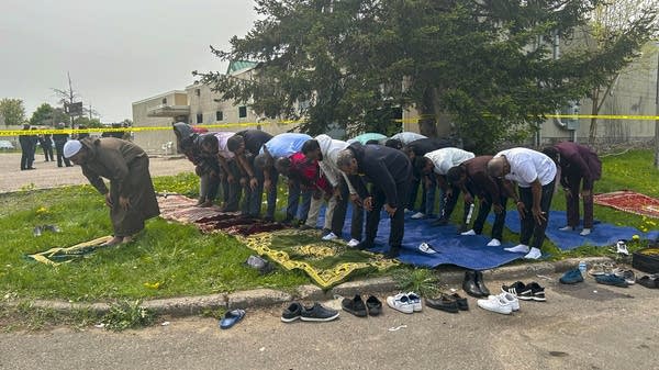 Muslims from the local community pray outside 