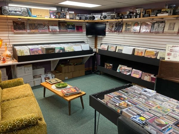 A room filled with records, CDs, vintage cameras and audio gear