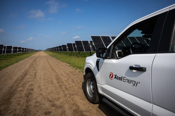 A white truck parked in a solar array
