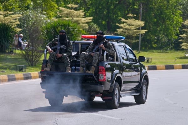 Soldiers sitting in back of pickup