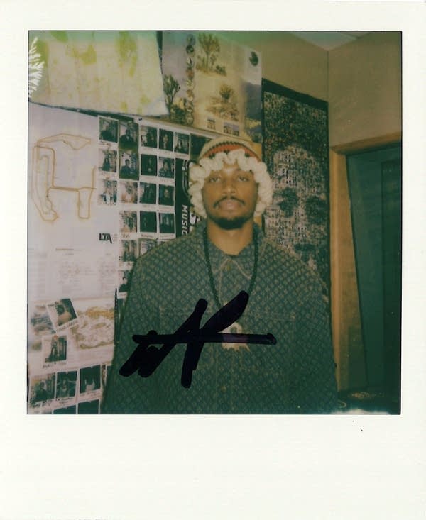 a man posing in a polaroid photo in the carbon sound studio