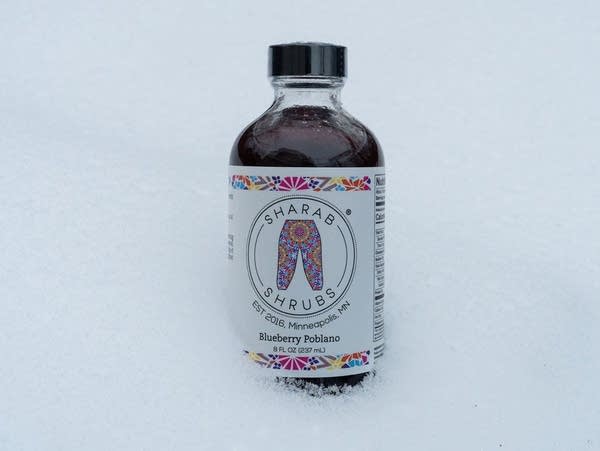 A glass bottle of Sherab Shrubs.