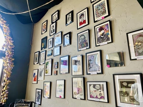 Self portraits hanging on a wall