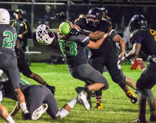 Edina football player gets his helmet knocked off.