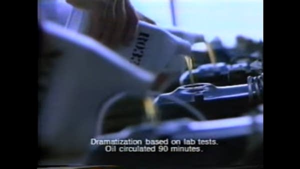 Still from TV commercial showing generic oil poured into engines