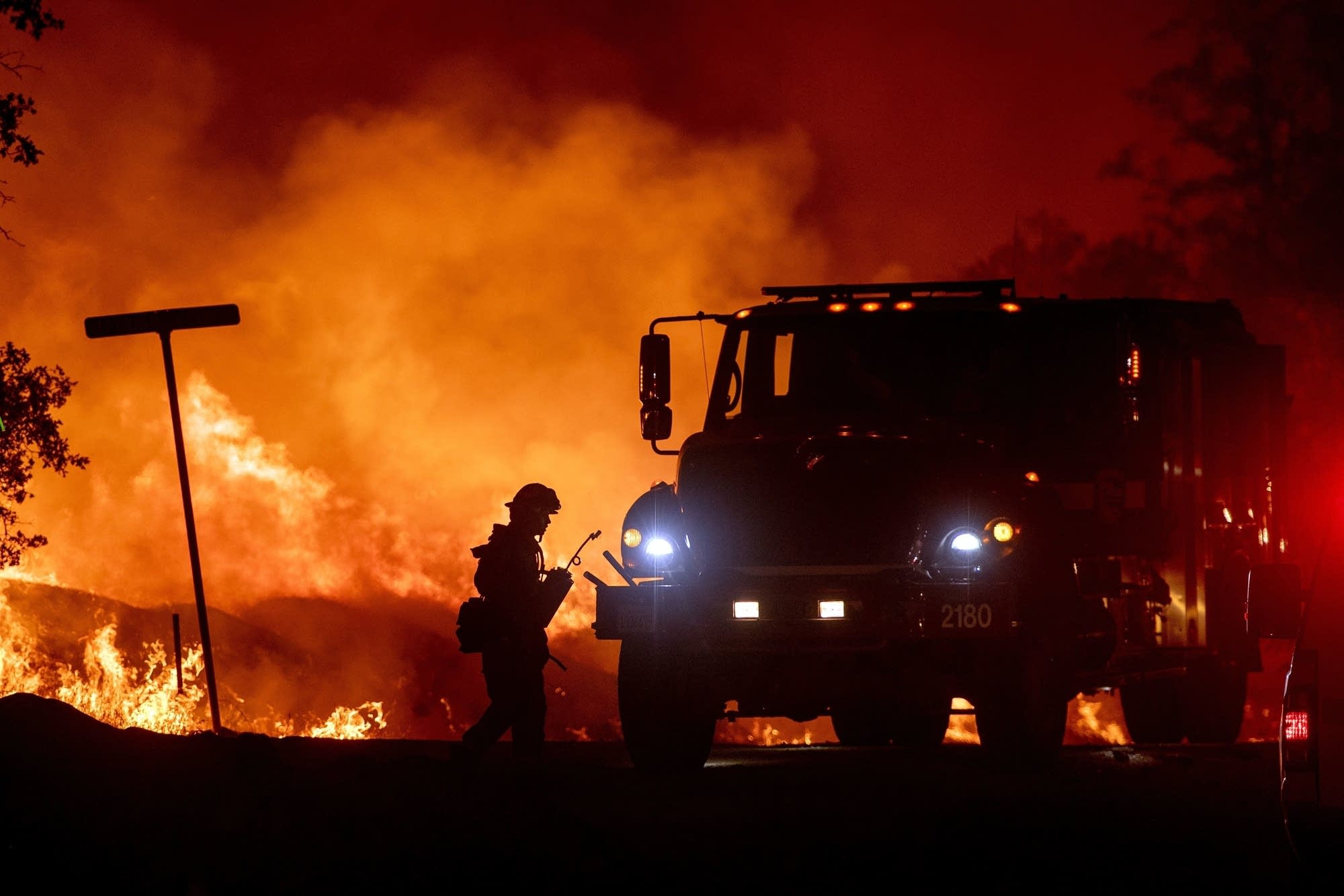 A firefighter lights backfires during the Carr fire in Redding